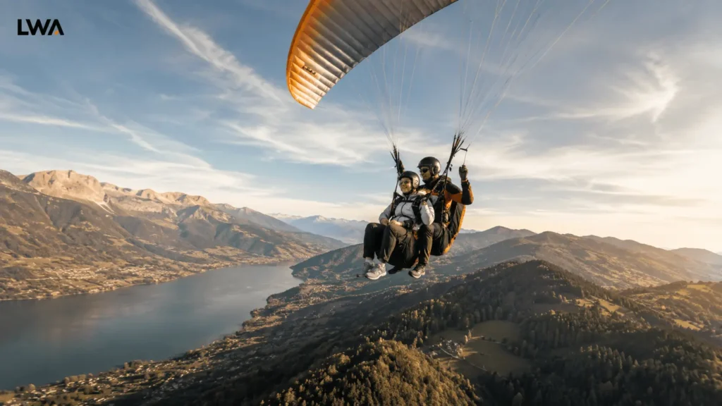 Tandem skydivers enjoying a calm parachute descent with expansive scenery below.